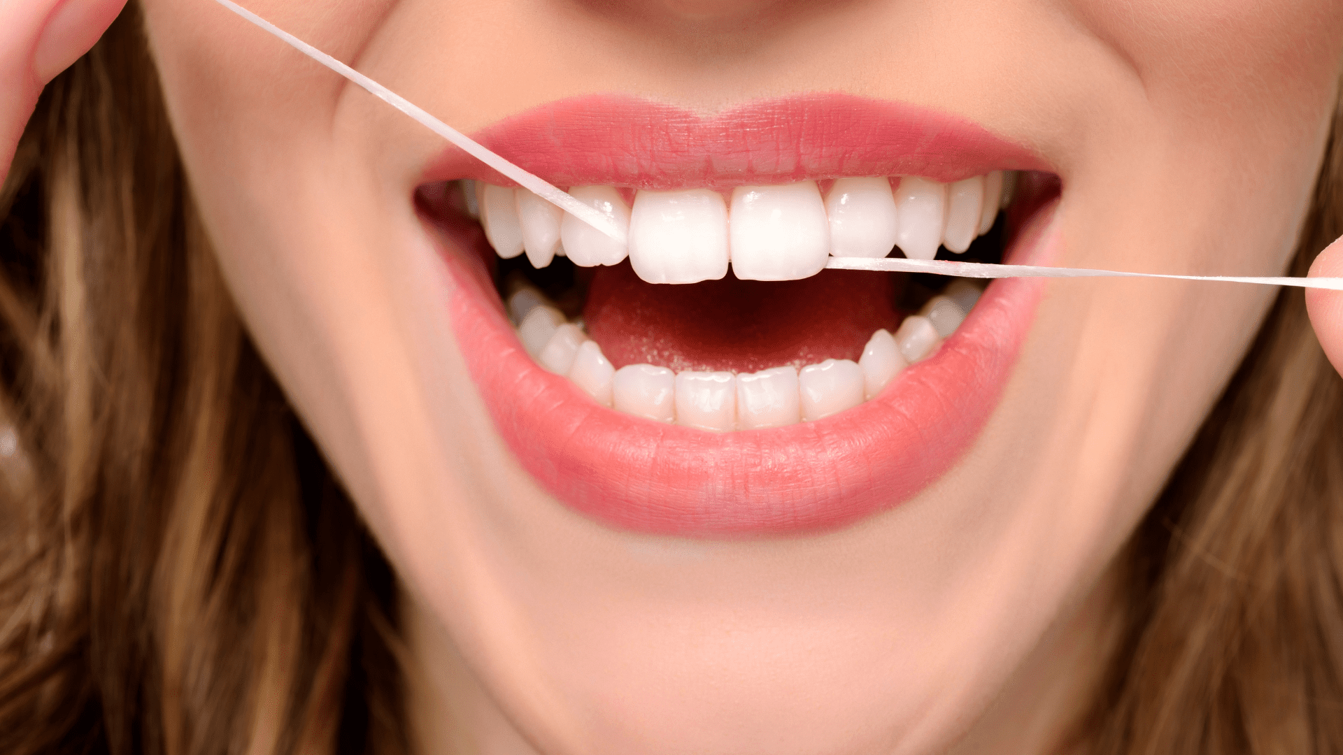 Woman Flossing Teeth | Dentist Louisville, KY